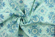 Load image into Gallery viewer, This outdoor fabric features a medallion design in blues, beige, white, turquoise, mint green, and pale green . 

