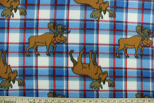 Load image into Gallery viewer, This ultra soft, medium weight printed fleece is the go to fabric for warmth.  The blue, white and red plaid features a brown elk and is perfect for creating jackets, vests, scarves, gloves, throws, bedding and more!

