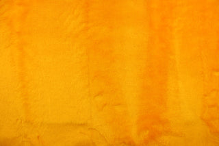  A faux fur in a solid bright yellow with orange undertones.