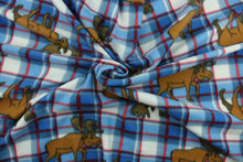 Load image into Gallery viewer, This ultra soft, medium weight printed fleece is the go to fabric for warmth.  The blue, white and red plaid features a brown elk and is perfect for creating jackets, vests, scarves, gloves, throws, bedding and more!
