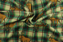 Load image into Gallery viewer, This ultra soft, medium weight printed fleece is the go to fabric for warmth.  The green, red and taupe plaid features a brown elk and is perfect for creating jackets, vests, scarves, gloves, throws, bedding and more!  We offer this design in other colors.
