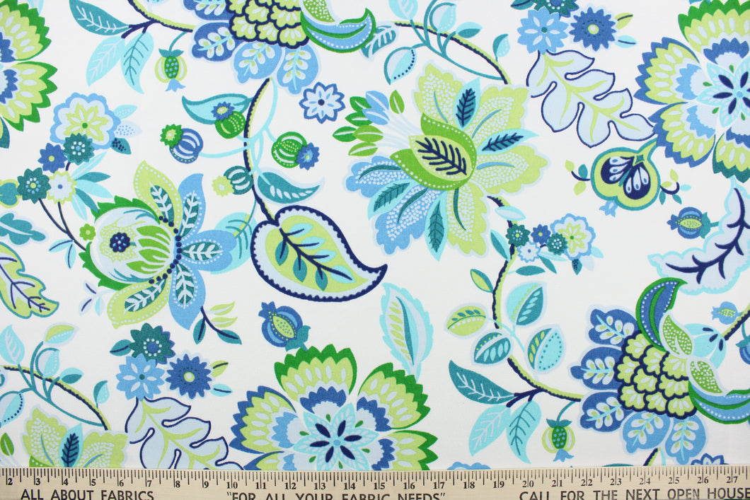  This outdoor fabric features a floral print in varying shades of green, blue, turquoise, and pale gray against a white  background and is perfect for any project where the fabric will be exposed to the weather. 