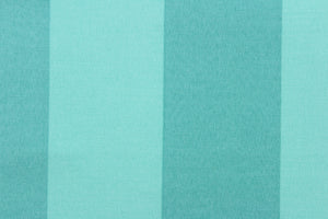  This fabric outdoor features a stripe design in shades of turquoise. 