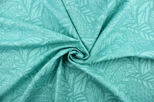 Load image into Gallery viewer,  This outdoor fabric features a leaf design in shades of turquoise . 
