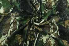 Load image into Gallery viewer, This ultra soft, medium weight printed fleece is the go to fabric for warmth.  The camouflage design in the colors of green, black, brown and off white is perfect for creating jackets, vests, scarves, gloves, throws, bedding and more! 
