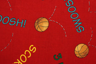 Team Teddy features basketballs and basketball terminology in orange, yellow, green, blue and teal on a red background.  The versatile lightweight fabric is soft and easy to sew.  It would be great for quilting, crafting and sewing projects.  