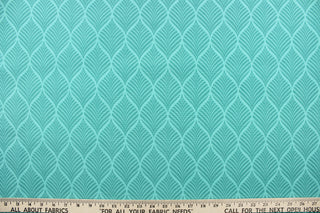 This outdoor fabric features a leaf design in shades of teal green. 