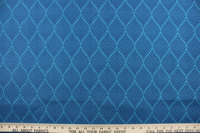  This outdoor fabric features a leaf design in shades of blue.