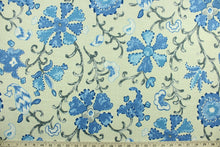 Load image into Gallery viewer, This multi purpose linen/rayon blend fabric features a large floral and vine design in shades of blue, gray and white against a light beige background.  It can be used for several different statement projects including window accents (drapery, curtains and swags), decorative pillows, hand bags, bed skirts, duvet covers, upholstery and craft projects.  It has a soft workable feel yet is stable and has a durability rating that exceeds 15,000 double rubs. 
