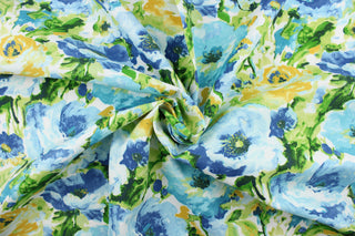 This outdoor fabric features a beautiful floral design in blue, green, yellow, and white. 