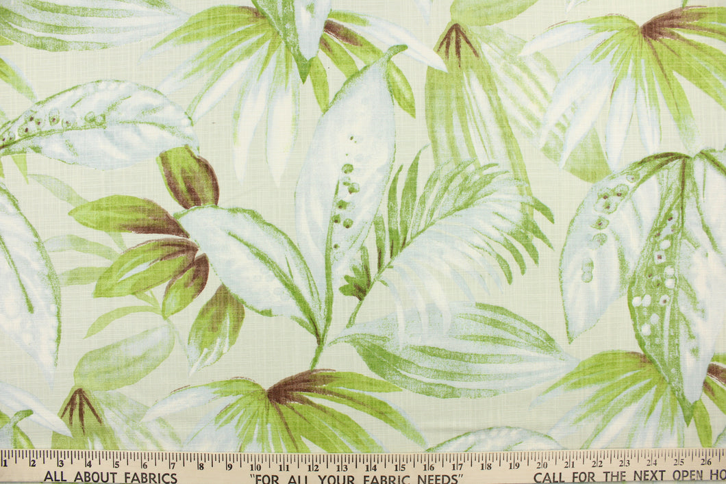  This fabric features a leaf design in green, brown, and pale blue against a natural white background.