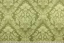Load image into Gallery viewer, This multi purpose fabric features a a damask design in beige and olive green.  It can be used for several different statement projects including window accents (drapery, curtains and swags), decorative pillows, hand bags, bed skirts, duvet covers, upholstery and craft projects.  It has a soft workable feel yet is stable and durable.
