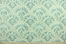 Load image into Gallery viewer, Tomini features a scalloped design in shades of green with blue accents on a natural background.  It can be used for several different statement projects including window accents (drapery, curtains and swags), decorative pillows, hand bags, bed skirts, duvet covers, upholstery and craft projects.  It has a soft workable feel yet is stable and durable with 15,000 double rubs. 
