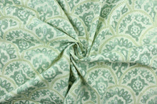 Load image into Gallery viewer, Tomini features a scalloped design in shades of green with blue accents on a natural background.  It can be used for several different statement projects including window accents (drapery, curtains and swags), decorative pillows, hand bags, bed skirts, duvet covers, upholstery and craft projects.  It has a soft workable feel yet is stable and durable with 15,000 double rubs. 
