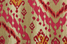 Load image into Gallery viewer, This multi purpose cotton/linen blend fabric features an ikat design in mulberry, pink, orange and brown.  It can be used for several different statement projects including window accents (drapery, curtains and swags), decorative pillows, hand bags, bed skirts, duvet covers, upholstery and craft projects.  It has a soft workable feel yet is stable and durable with 5,000 double rubs. 
