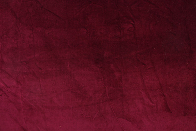  An upholstery velvet in a beautiful solid rich burgundy .