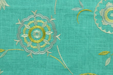 Load image into Gallery viewer, Suzani features an embroidered ethnic design in shades of green and gold against an aqua background.  Uses include drapery, pillows, light upholstery, table runners, bedding, headboards, and home décor.

