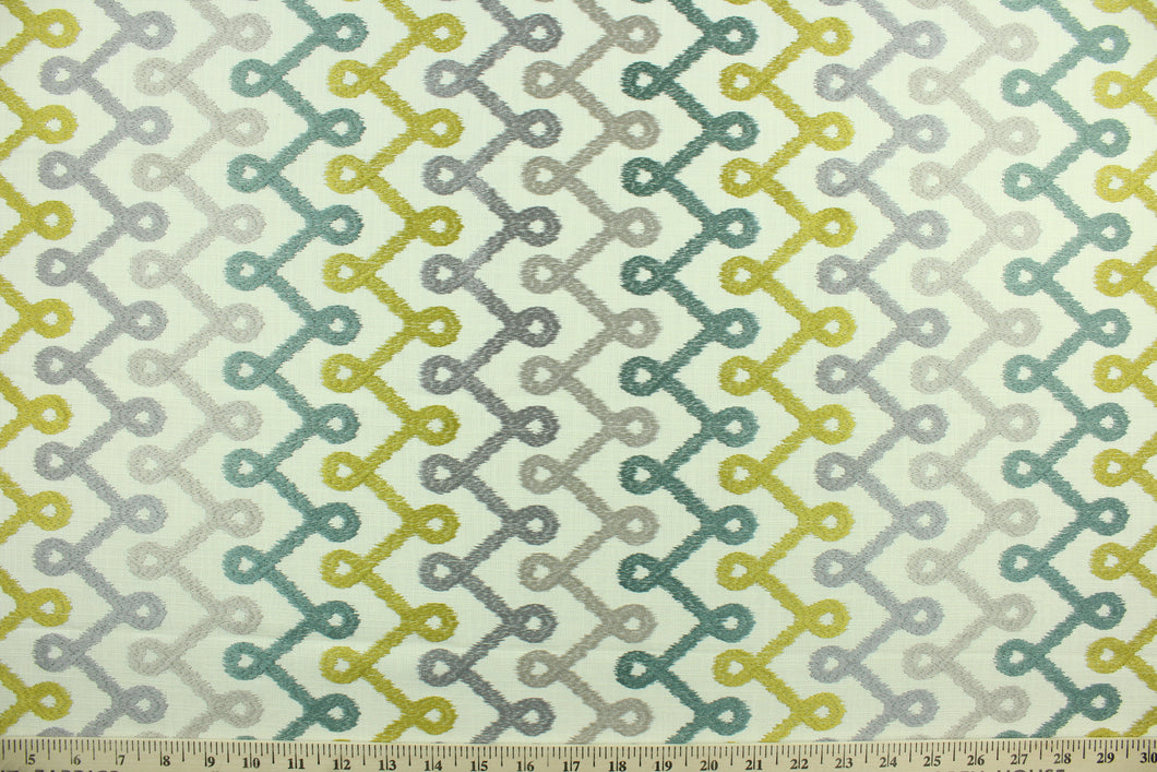 Medicago is a contemporary geometric design embroidered in citrus yellow, teal, champagne and light purple on an off white background.  Use this for light upholstery, pillows, bedding and window treatments.  