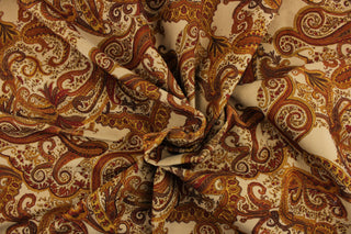This velvet features a paisley design in brown, golden tan, deep orange, and rich red against  a beige background . 