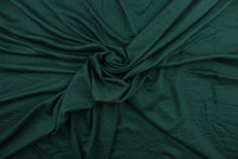Load image into Gallery viewer, Hunter is a solid, dark green, cotton jersey fabric, has a 4-way stretch that is soft, durable, breathable and will allow movements of the body.  Uses include t-shirts, sportswear, loungewear, leggings, children&#39;s apparel, bedding and sheets.  We offer a variety of jersey fabrics.
