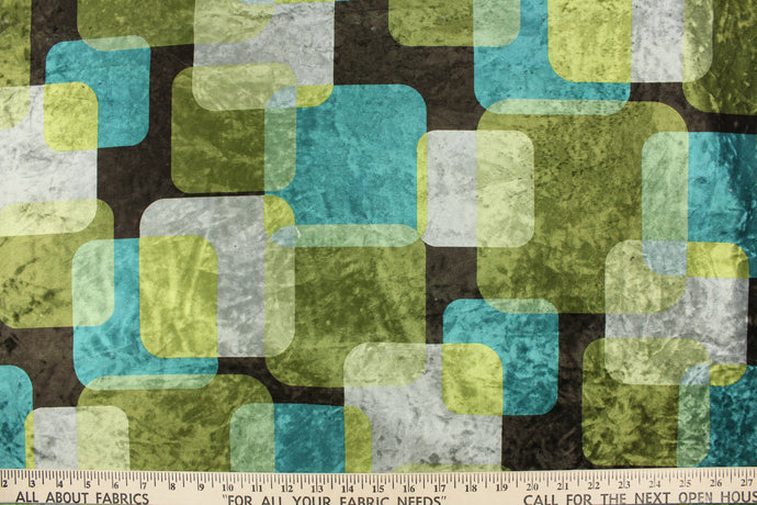 This velvet features a geometric design in green, brown, teal, gray, and moss green .