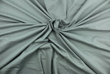 Load image into Gallery viewer, This silver cotton jersey fabric, has a 4-way stretch that is soft, durable, breathable and will allow movements of the body.  Uses include t-shirts, sportswear, loungewear, leggings, children&#39;s apparel, bedding and sheets.  We offer a variety of jersey fabrics.
