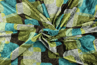 This velvet features a geometric design in green, brown, teal, gray, and moss green .