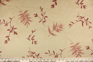 This velvet features a leaf design in mauve, and maroon against a pale beige  . 