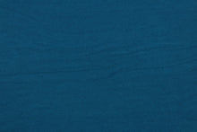 Load image into Gallery viewer, This turquoise cotton jersey fabric, has a 4-way stretch that is soft, durable, breathable and will allow movements of the body.  Uses include t-shirts, sportswear, loungewear, leggings, children&#39;s apparel, bedding and sheets.  We offer a variety of jersey fabrics.

