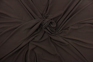 This chocolate brown, cotton jersey fabric, has a 4-way stretch that is soft, durable, breathable and will allow movements of the body.  Uses include t-shirts, sportswear, loungewear, leggings, children's apparel, bedding and sheets.  We offer a variety of jersey fabrics.