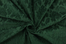 Load image into Gallery viewer, An upholstery velvet featuring a floral design in a rich green.
