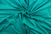 Load image into Gallery viewer, This aqua cotton jersey fabric, has a 4-way stretch that is soft, durable, breathable and will allow movements of the body.  Uses include t-shirts, sportswear, loungewear, leggings, children&#39;s apparel, bedding and sheets.  We offer a variety of jersey fabrics.
