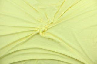 This lemon yellow, cotton jersey fabric, has a 4-way stretch that is soft, durable, breathable and will allow movements of the body.  Uses include t-shirts, sportswear, loungewear, leggings, children's apparel, bedding and sheets.  We offer a variety of jersey fabrics.