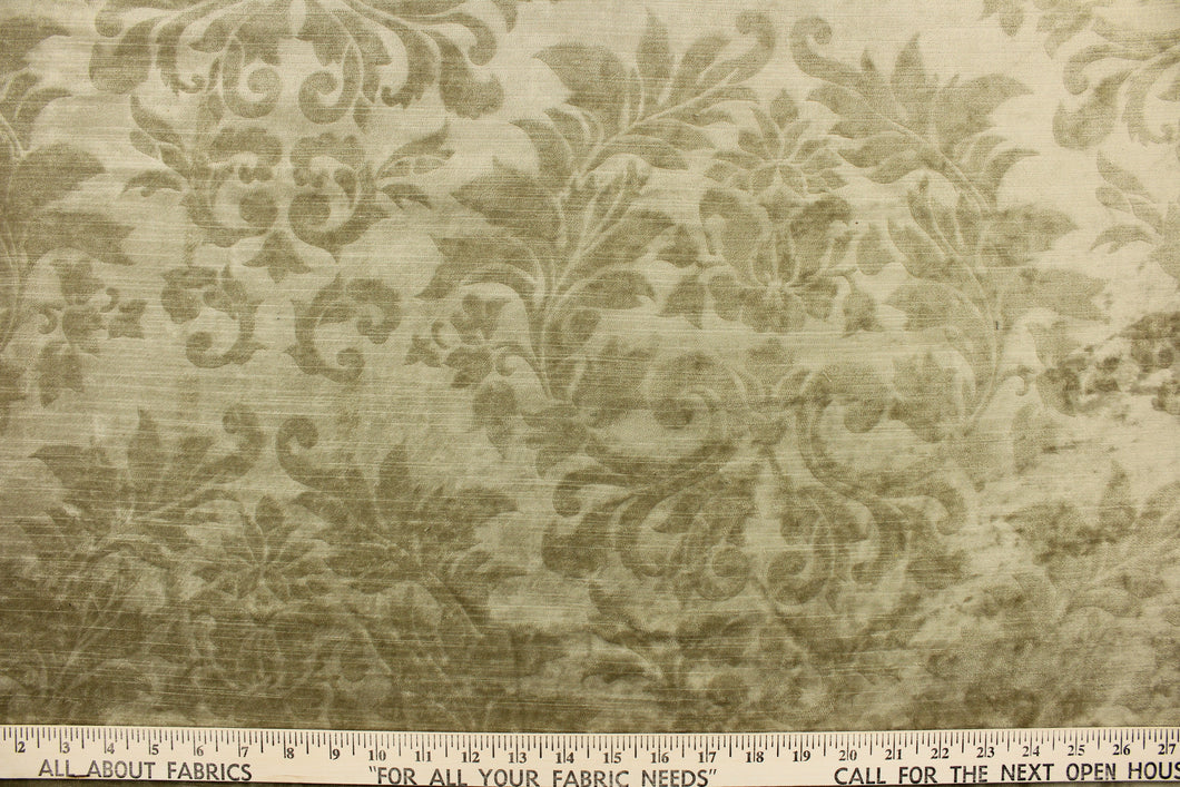 : An upholstery velvet featuring a floral/demask design in a tone on tone beige.