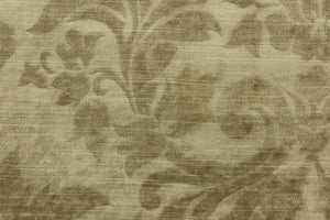 : An upholstery velvet featuring a floral/demask design in a tone on tone beige.
