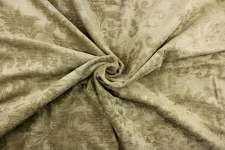 : An upholstery velvet featuring a floral/demask design in a tone on tone beige.