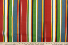 Load image into Gallery viewer,  This outdoor fabric features bright stripes in red, blue, white, golden yellow, green, and navy 
