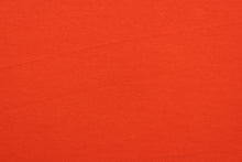 Load image into Gallery viewer, This orange cotton jersey fabric, has a 4-way stretch that is soft, durable, breathable and will allow movements of the body.  Uses include t-shirts, sportswear, loungewear, leggings, children&#39;s apparel, bedding and sheets.  We offer a variety of jersey fabrics.

