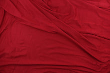 Load image into Gallery viewer, Scarlet is a red cotton jersey fabric, has a 4-way stretch that is soft, durable, breathable and will allow movements of the body.  Uses include t-shirts, sportswear, loungewear, leggings, children&#39;s apparel, bedding and sheets.  We offer a variety of jersey fabrics.

