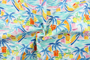This outdoor fabric features a tropical outdoor design in pink, blue, turquoise, orange, golden yellow, and white. 