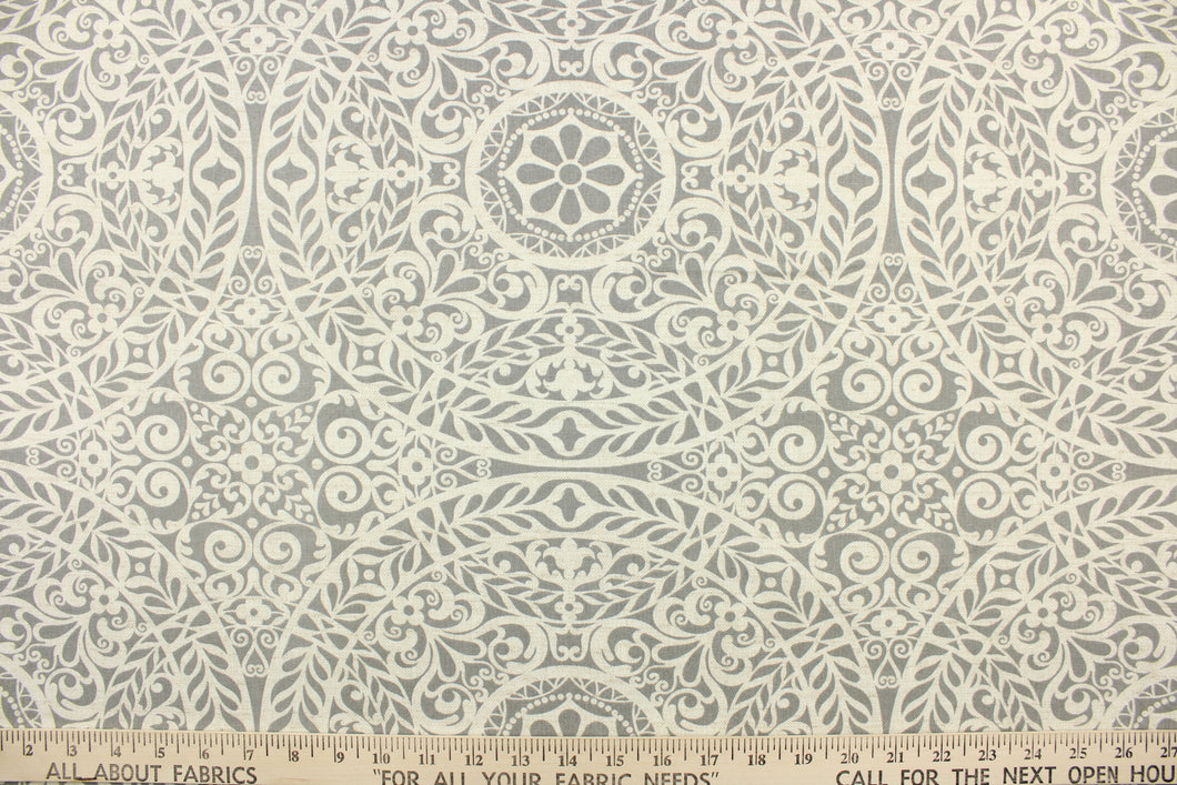 This fabric features a medallion design in gray and pale beige with hints of white. 
