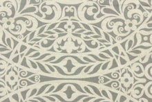 Load image into Gallery viewer, This fabric features a medallion design in gray and pale beige with hints of white. 
