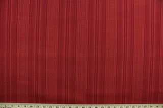 This Solarium outdoor decorative print features a duotone stripe design in berry.  This versatile, long-lasting fabric can withstand up to 500 hours of sunlight, water and stain resistant and has 10,000 double rubs.  It is perfect for lounge cushions, pool furniture, tablecloths, decorative pillows and upholstery projects.  This fabric has a slightly stiff feel but is easy to work with.  