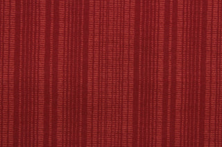 This Solarium outdoor decorative print features a duotone stripe design in berry.  This versatile, long-lasting fabric can withstand up to 500 hours of sunlight, water and stain resistant and has 10,000 double rubs.  It is perfect for lounge cushions, pool furniture, tablecloths, decorative pillows and upholstery projects.  This fabric has a slightly stiff feel but is easy to work with.  