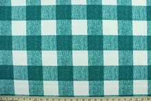 Load image into Gallery viewer, This Solarium outdoor decorative print features a plaid design in peacock green and white.  This versatile, long-lasting fabric can withstand up to 500 hours of sunlight, water and stain resistant and has 15,000 double rubs.  It is perfect for lounge cushions, pool furniture, tablecloths, decorative pillows and upholstery projects.  This fabric has a slightly stiff feel but is easy to work with.  
