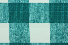 Load image into Gallery viewer, This Solarium outdoor decorative print features a plaid design in peacock green and white.  This versatile, long-lasting fabric can withstand up to 500 hours of sunlight, water and stain resistant and has 15,000 double rubs.  It is perfect for lounge cushions, pool furniture, tablecloths, decorative pillows and upholstery projects.  This fabric has a slightly stiff feel but is easy to work with.  

