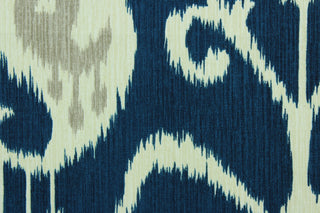Java features an ikat design in pale gray and ivory on a navy blue  background.  It can be used for several different statement projects including window accents (drapery, curtains and swags), decorative pillows, cornice boards, bed skirts, duvet covers, upholstery and craft projects.  It has a soft workable feel yet is stable and durable with 17,000 double rubs. .