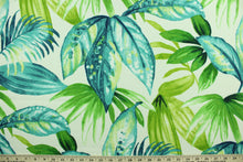 Load image into Gallery viewer, This Solarium outdoor decorative print features a large tropical leaf design in shades of green and blue on a white background.  This versatile, long-lasting fabric can withstand up to 500 hours of sunlight, water and stain resistant and has 10,000 double rubs.  It is perfect for lounge cushions, pool furniture, tablecloths, decorative pillows and upholstery projects.  This fabric has a slightly stiff feel but is easy to work with.  
