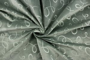  A velvet featuring a swirl design in a tone on tone light green . 