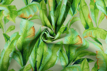 Load image into Gallery viewer, This Solarium outdoor decorative print features large banana leaves in shades of green and orange against a caramel background.  This versatile, long-lasting fabric can withstand up to 500 hours of sunlight, water and stain resistant and has 15,000 double rubs.  It is perfect for lounge cushions, pool furniture, tablecloths, decorative pillows and upholstery projects.  This fabric has a slightly stiff feel but is easy to work with.  
